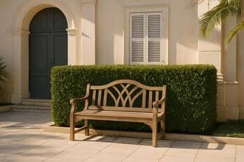 Simple bench in a sheltered hedge court beside glass